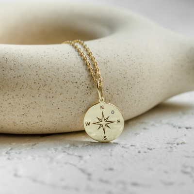 Gold pendant with a compass and a diamond MAP