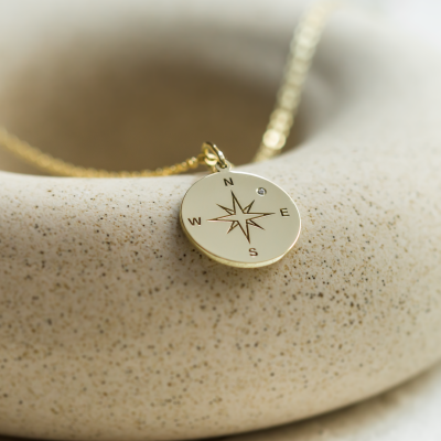 Gold pendant with a compass and a diamond MAP