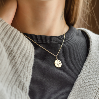 Gold pendant with a compass and a diamond MAP