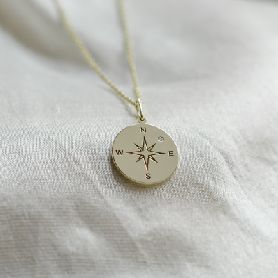 Gold pendant with a compass and a diamond MAP