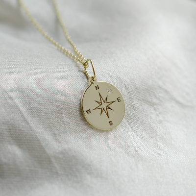 Gold pendant with a compass and a diamond MAP