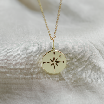 Gold pendant with a compass and a diamond MAP