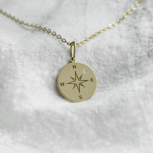 Gold pendant with a compass and a diamond MAP