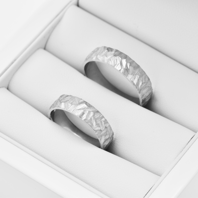 Gold wedding rings with a relief surface FIO