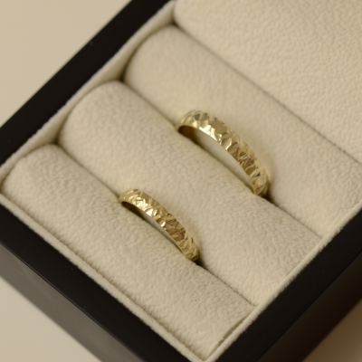 Gold wedding rings with a relief surface FIO