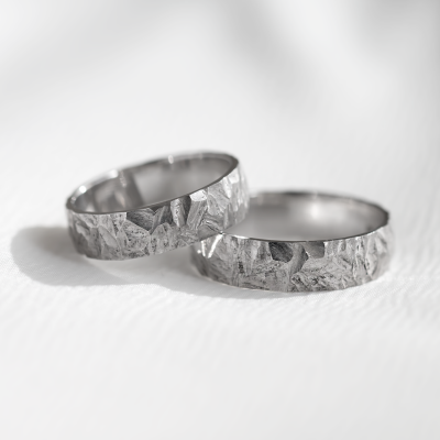 Gold wedding rings with a relief surface FIO