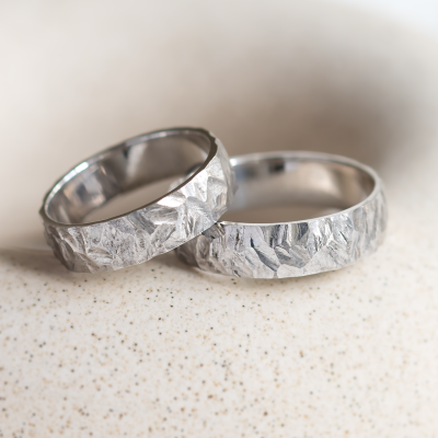 Gold wedding rings with a relief surface FIO