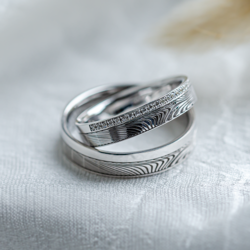 Original wedding rings with relief and diamonds PEACOCK